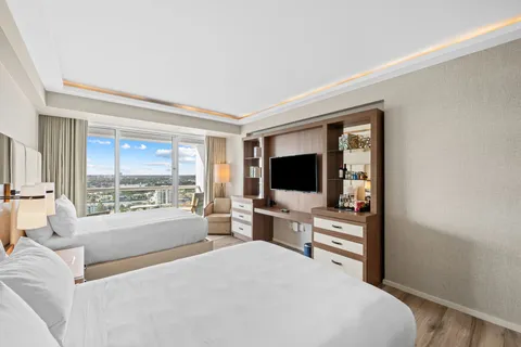 a bedroom with a bed and a flat screen tv