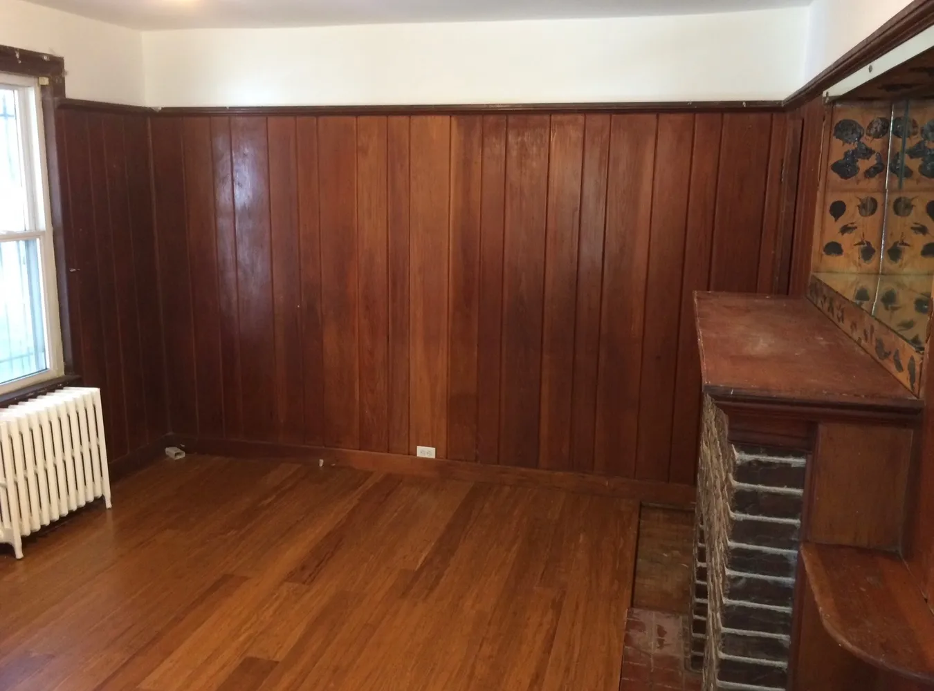 a view of a room with wooden floor and windows