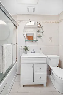 a bathroom with a sink mirror vanity and toilet