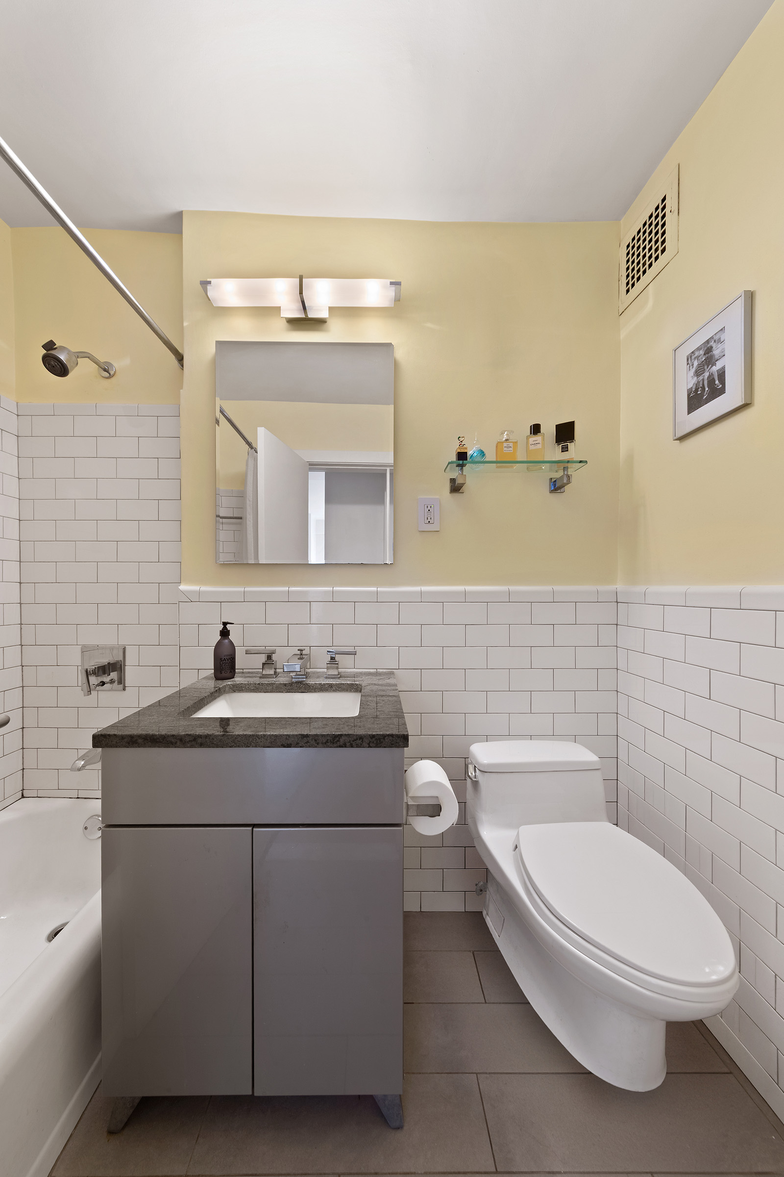 31 Jane Street, Unit 2CD Manhattan, NY 10014 - Photo 9 of 18 a bathroom with a toilet a sink and mirror
