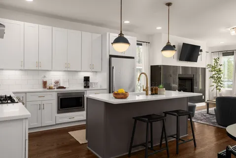 a kitchen with a stove cabinets and chairs