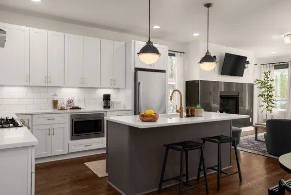 a kitchen with a stove cabinets and chairs