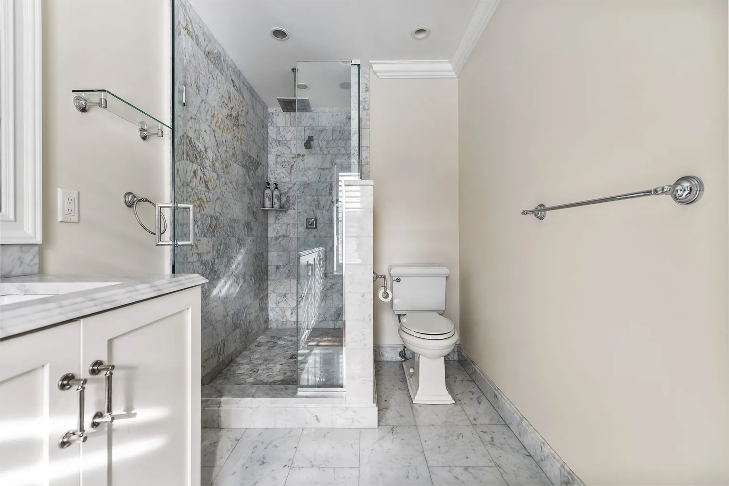 a bathroom with a granite countertop shower a toilet and a sink