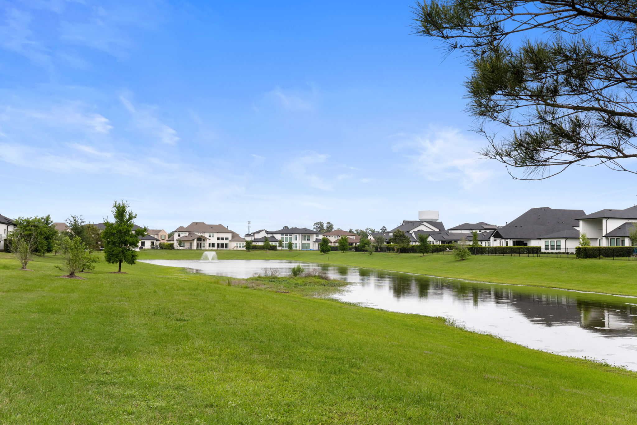 2118 Bennet Court Conroe, TX 77384 - Photo 68 of 70 a view of a lake with houses in the background