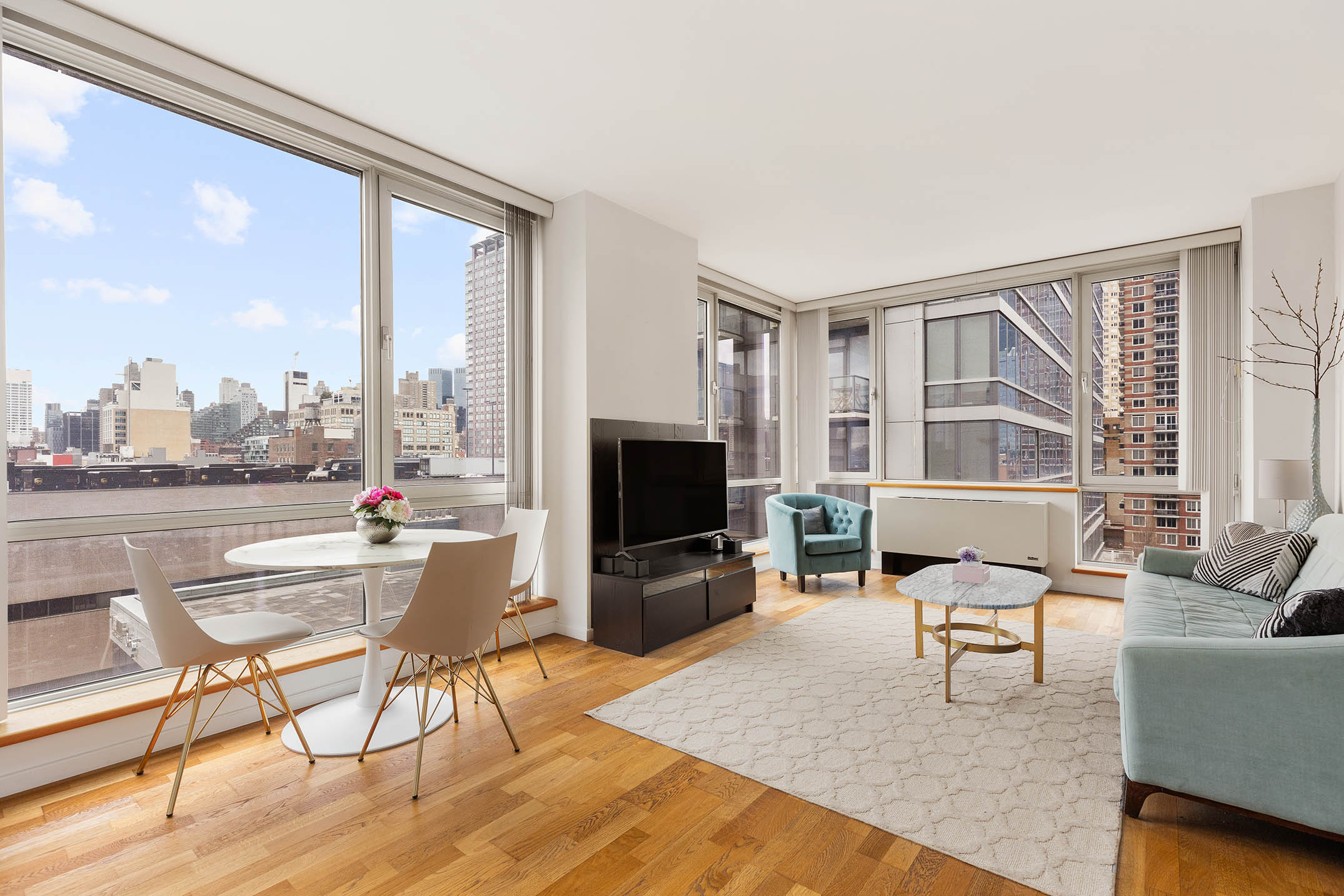 635 West 42nd Street, Unit 7F Manhattan, NY 10036 - Photo 2 of 7 a living room with fireplace furniture and a flat screen tv