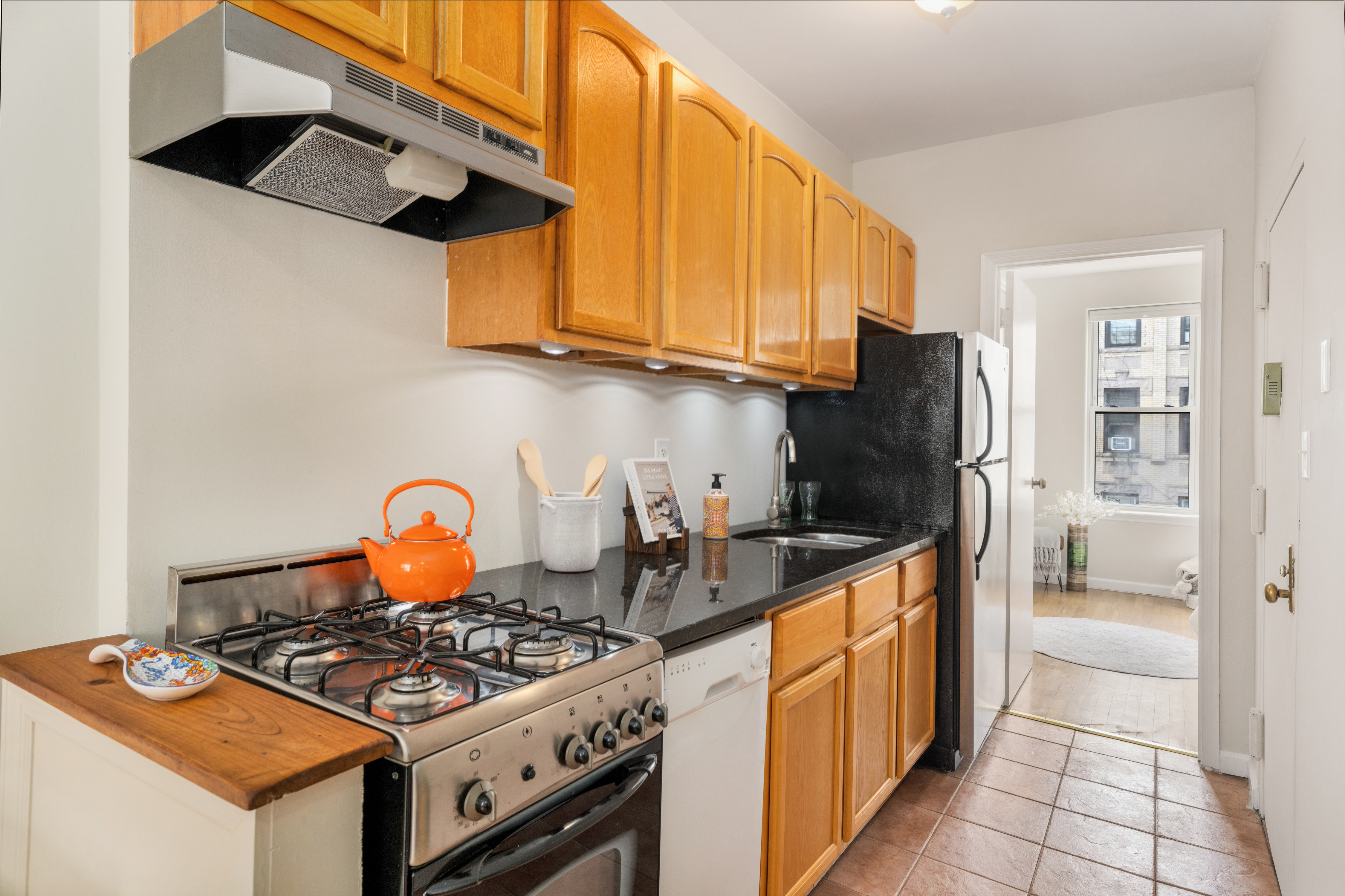 1286 Halsey Street, Unit 3B Brooklyn, NY 11237 - Photo 9 of 10 a kitchen with stainless steel appliances granite countertop a stove a refrigerator and a refrigerator