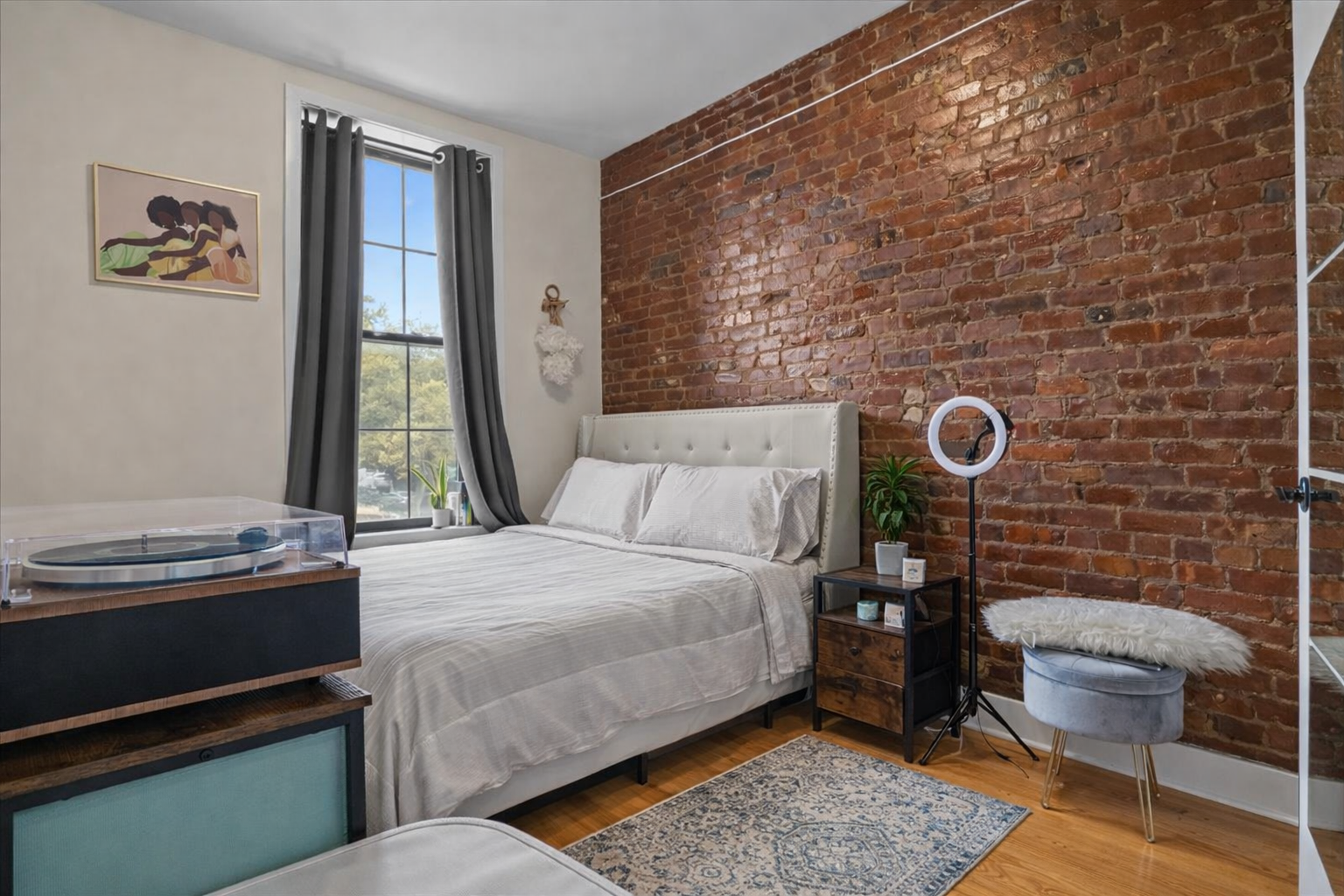 34 Rockaway Avenue, Unit MIXED Brooklyn, NY 11233 - Photo 4 of 11 a bed room with a bed and a window