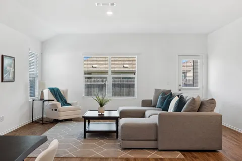 a living room with furniture and a large window