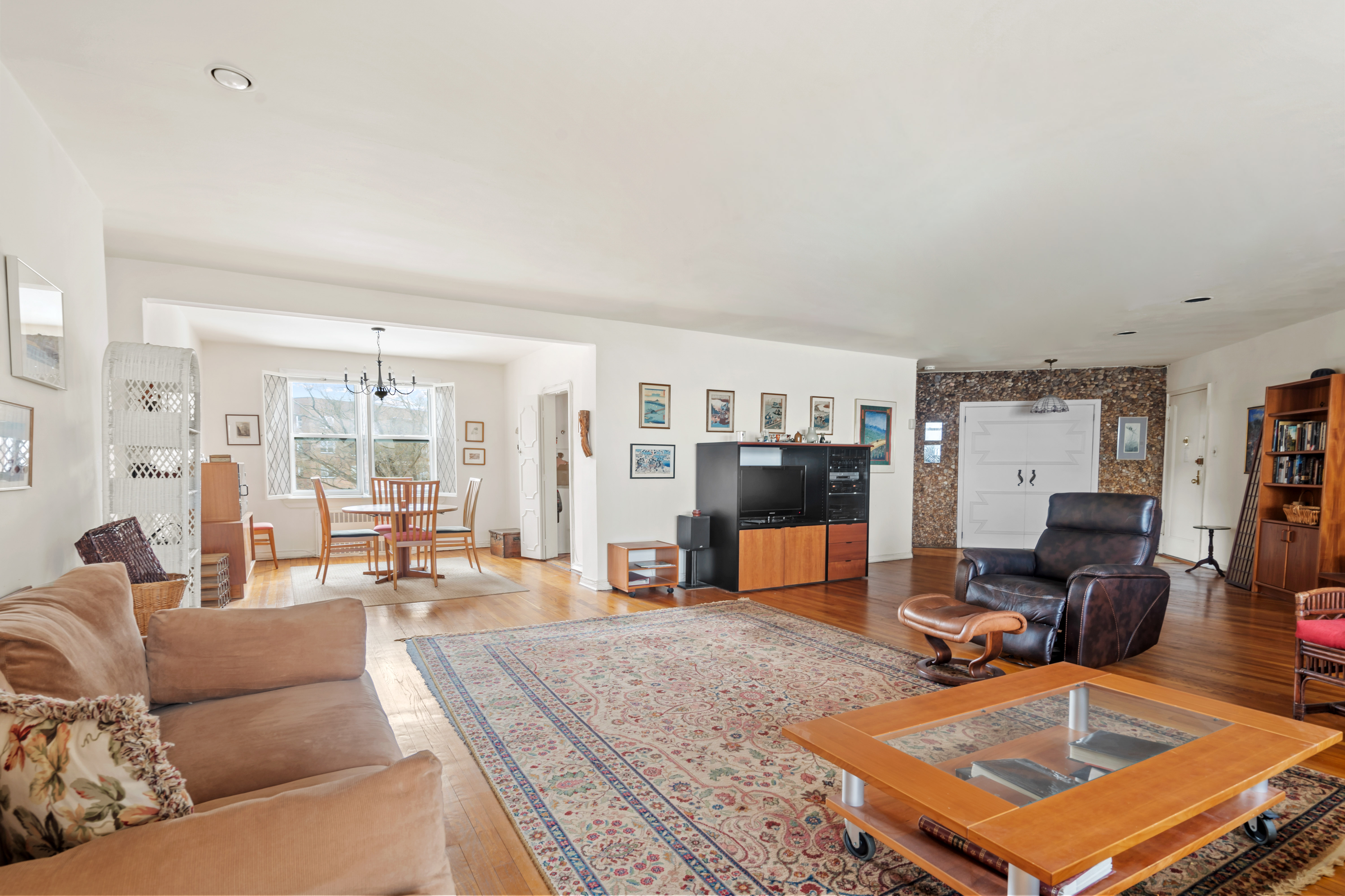 a living room with furniture a table and a large window