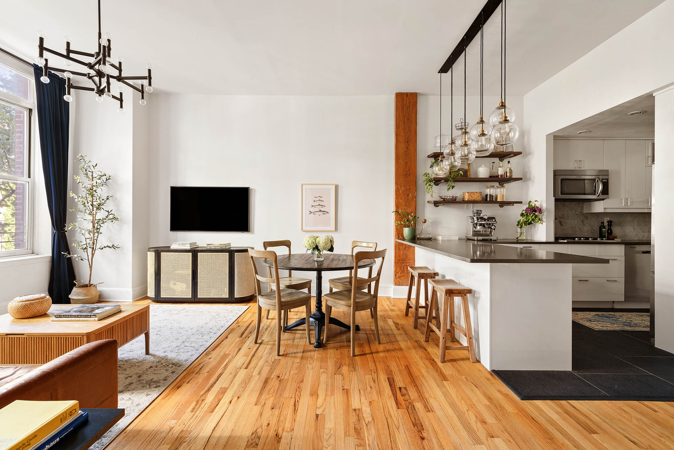 1 Tiffany Place, Unit 2F Brooklyn, NY 11231 - Photo 2 of 12 a kitchen with stainless steel appliances a kitchen island hardwood floor sink stove dining table and chairs
