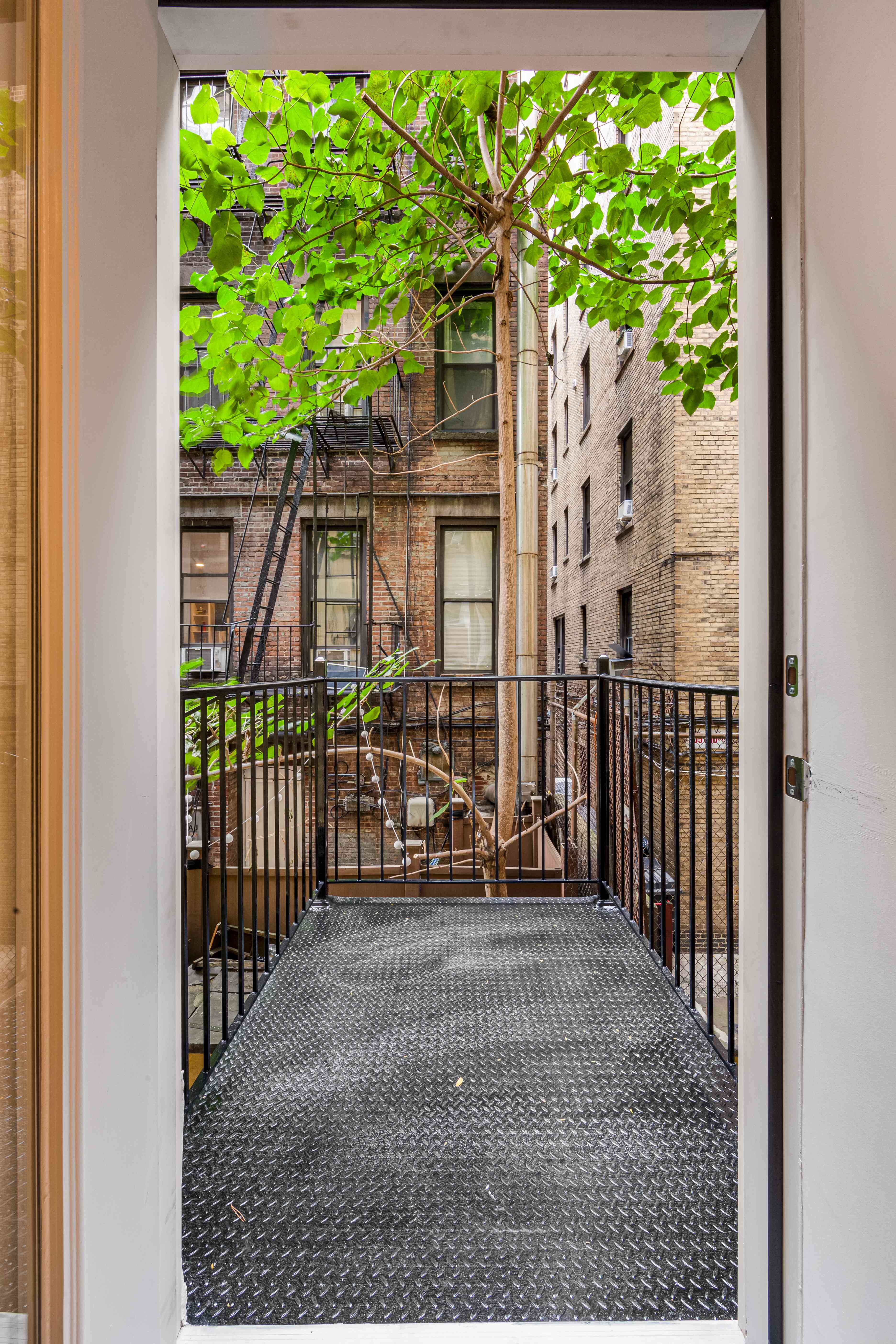 304 East 11th Street, Unit 1C Manhattan, NY 10003 - Photo 11 of 16 a view of a porch with wooden fence and floor