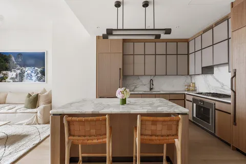 a kitchen with stainless steel appliances granite countertop a sink stove and cabinets