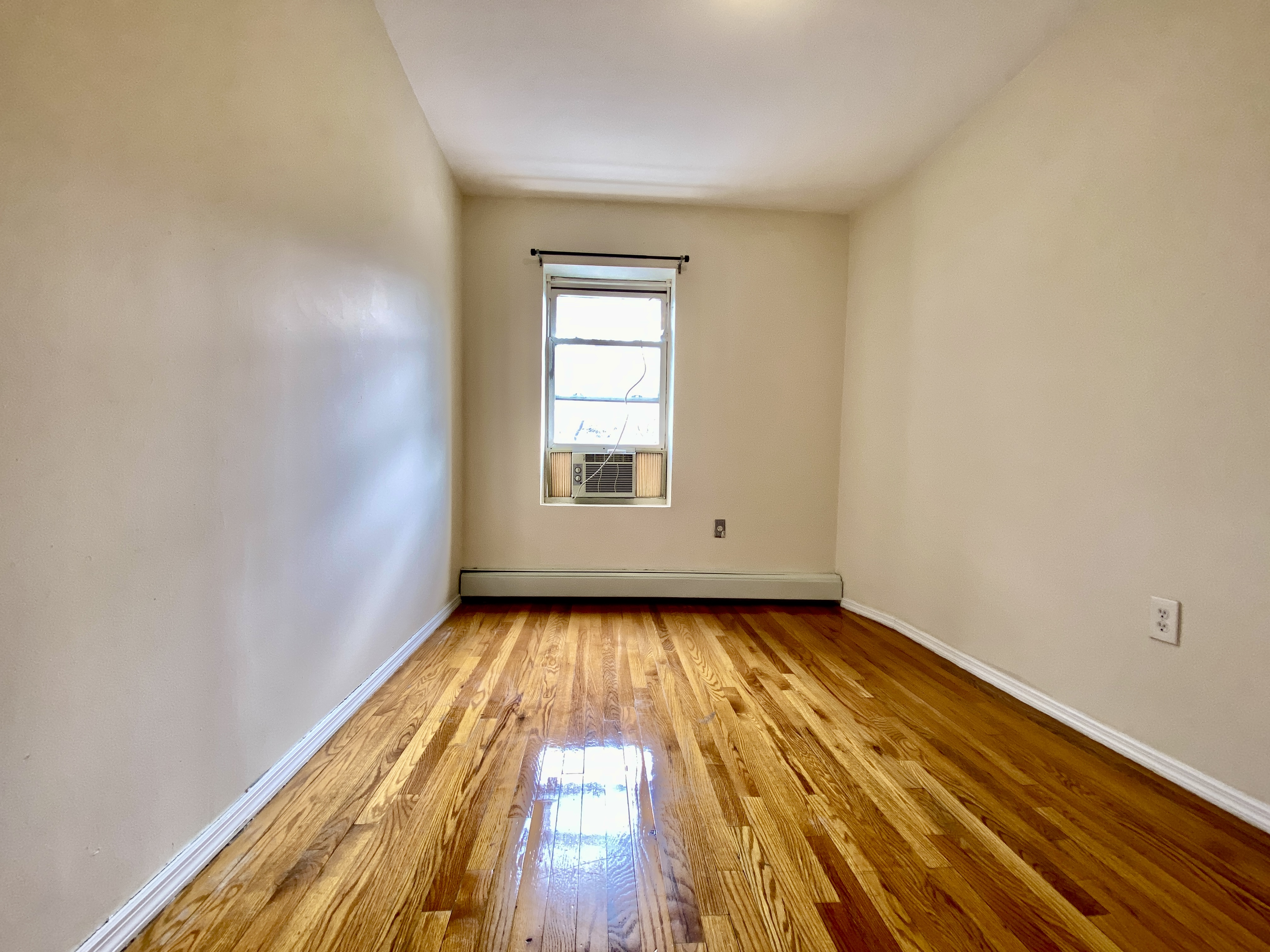 373 Gates Avenue, Unit 4 Brooklyn, NY 11216 - Photo 8 of 10 a view of a room with wooden floor and window
