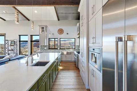 a dining hall with stainless steel appliances granite countertop a dishwasher a dining table and chairs with wooden floor