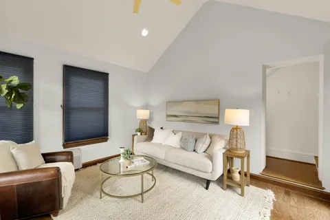 a living room with furniture and a floor to ceiling window
