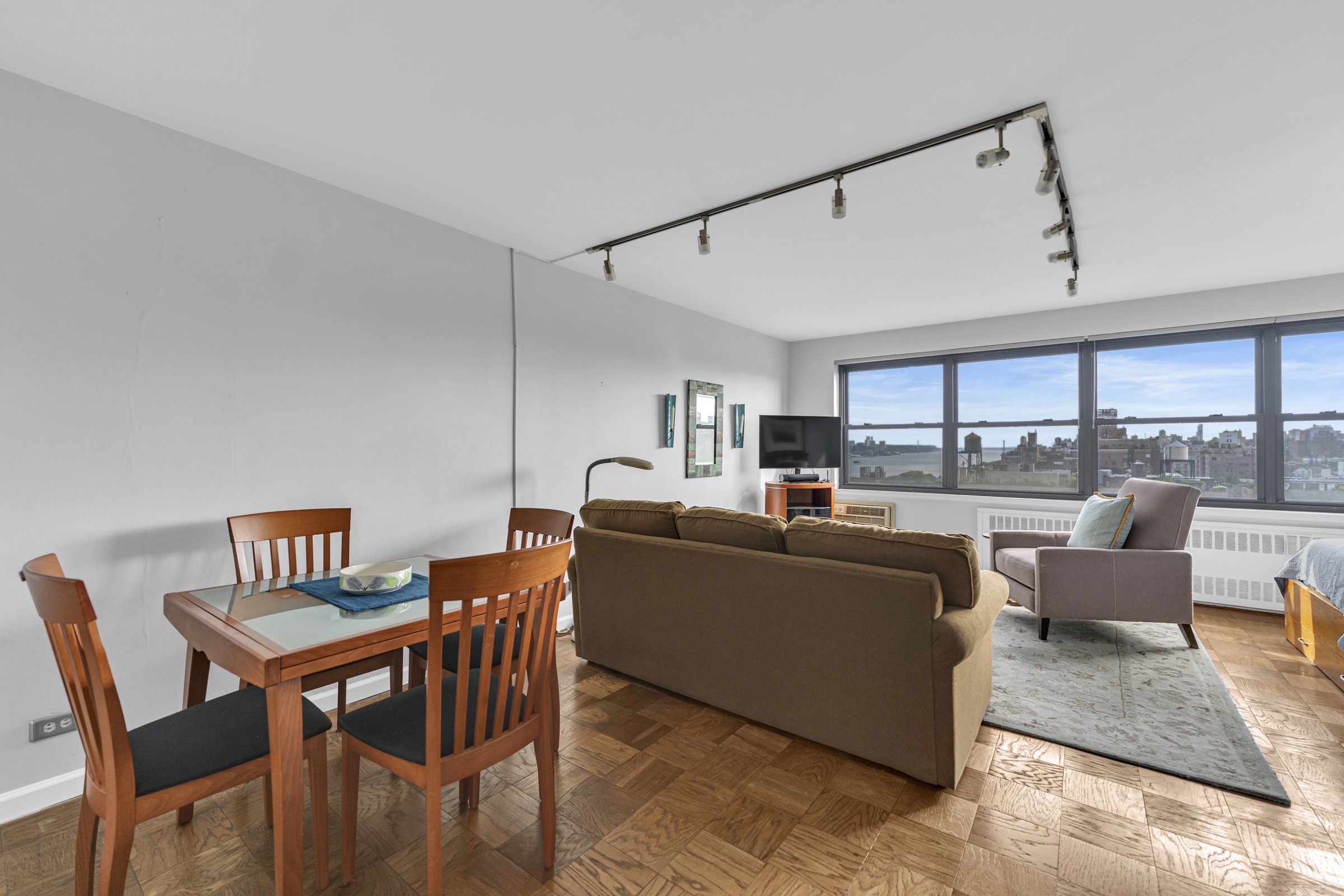 205 West End Avenue, Unit 23E Manhattan, NY 10023 - Photo 2 of 15 a living room with furniture a large window and a table