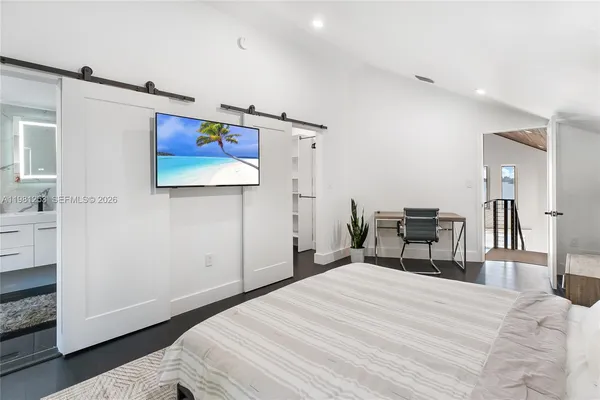 a bedroom with a bed and a television