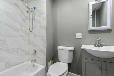 a bathroom with a toilet sink and shower