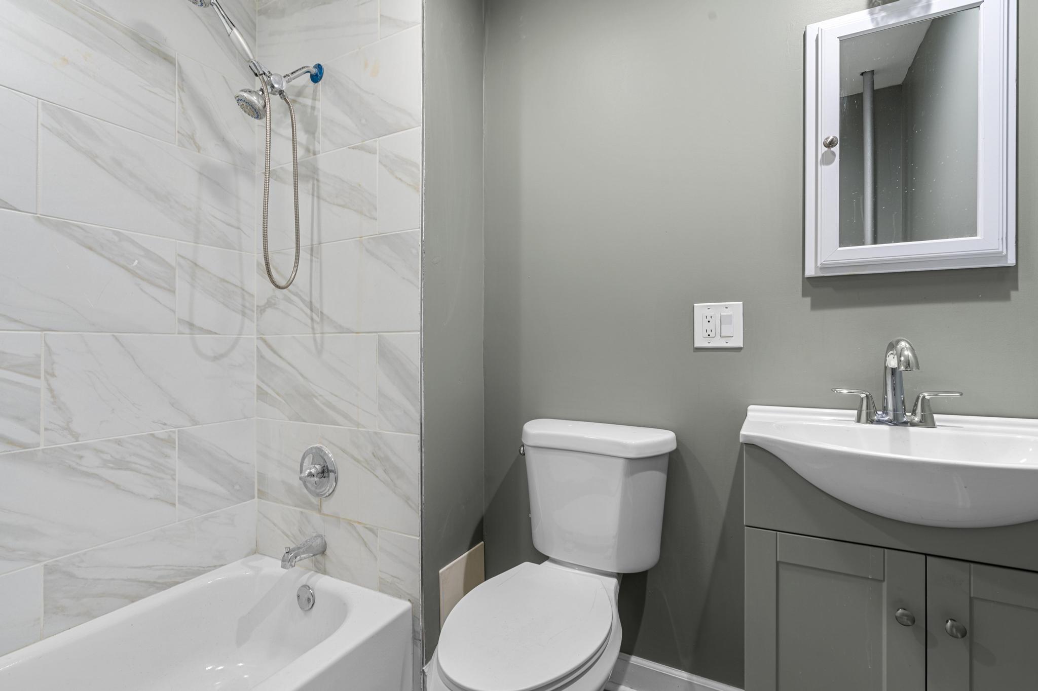 1328 Herkimer Street, Unit 1 Brooklyn, NY 11233 - Photo 8 of 9 a bathroom with a toilet sink and shower