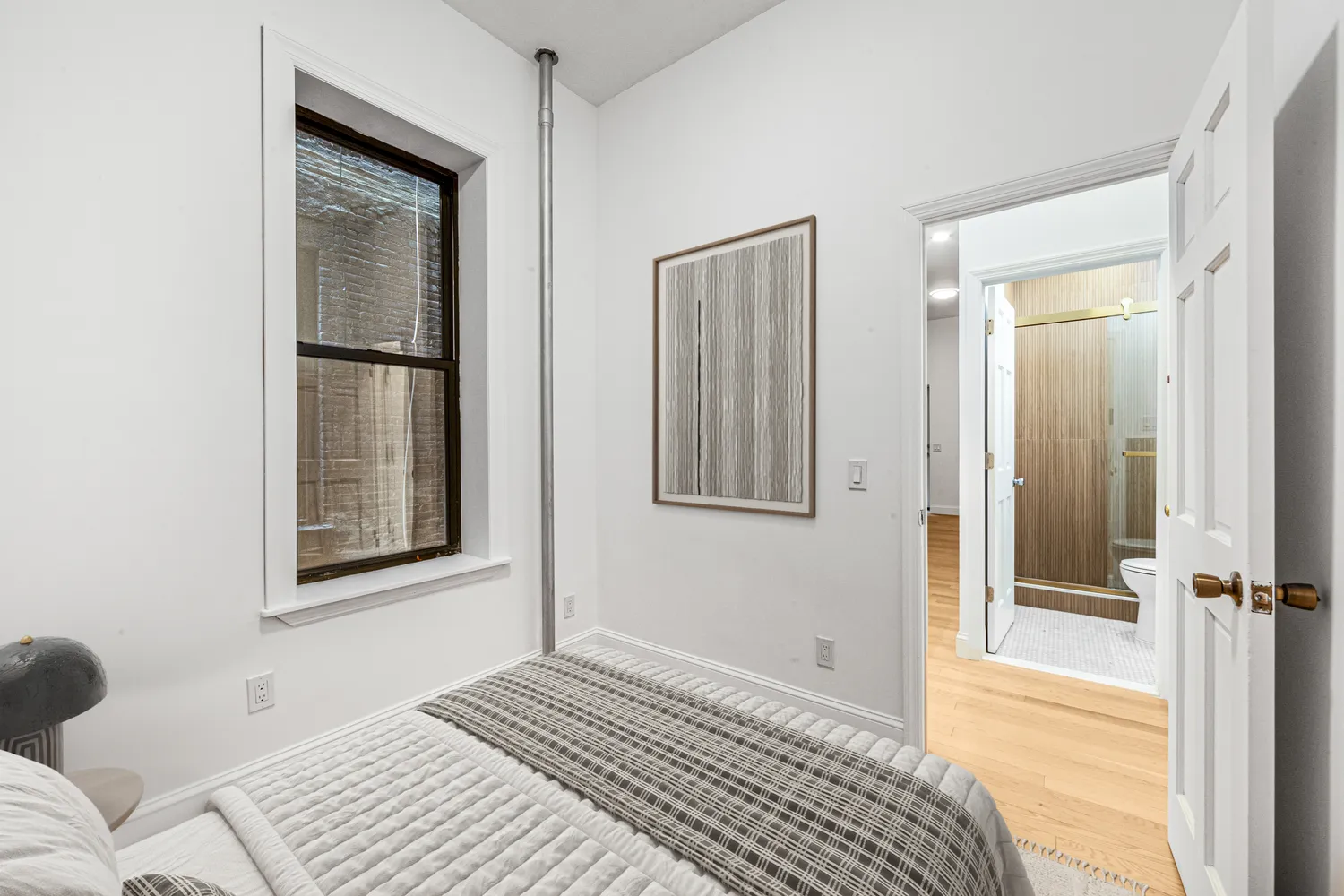 a bedroom with a bed and a window