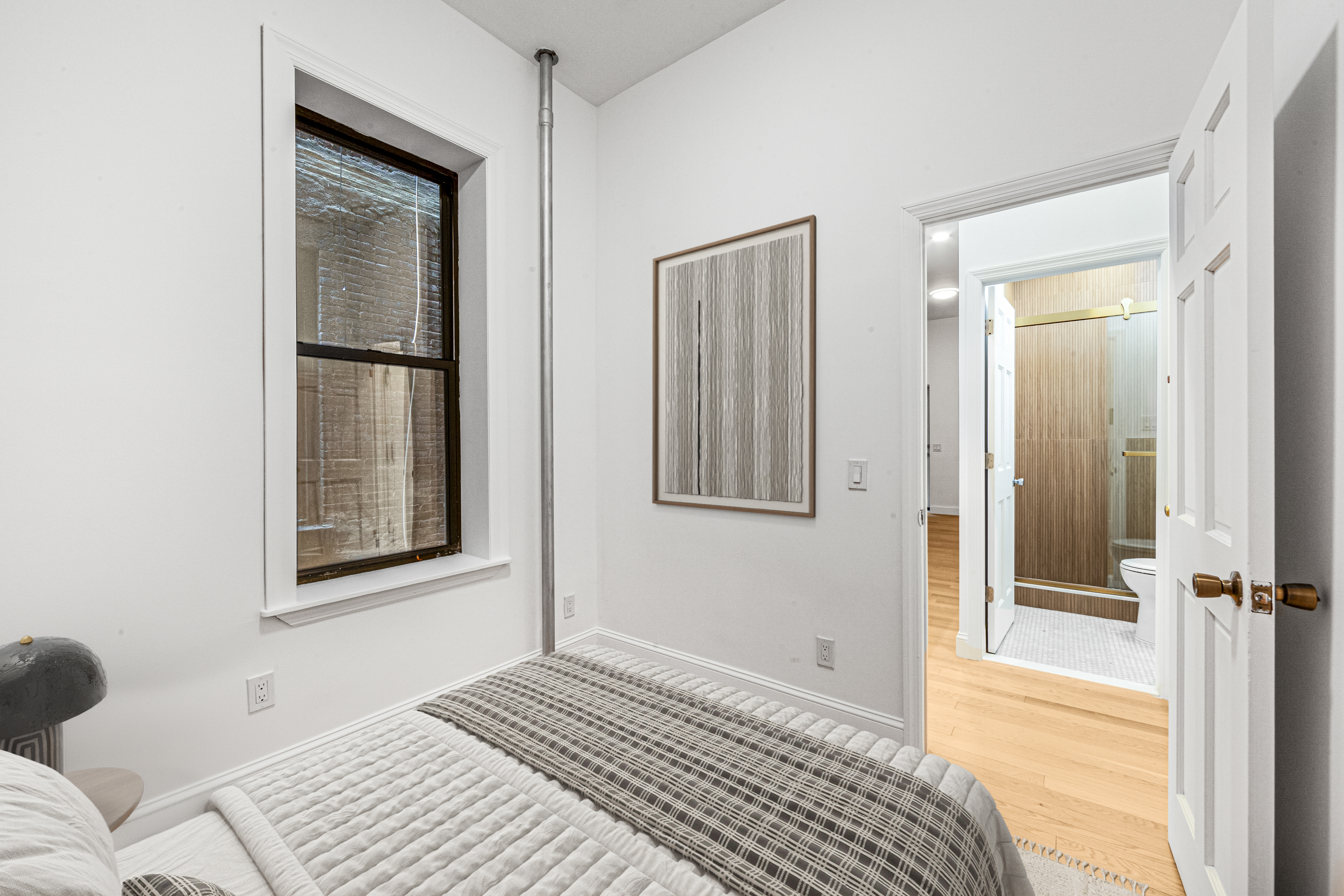 304 East 11th Street, Unit 1C Manhattan, NY 10003 - Photo 2 of 16 a bedroom with a bed and a window