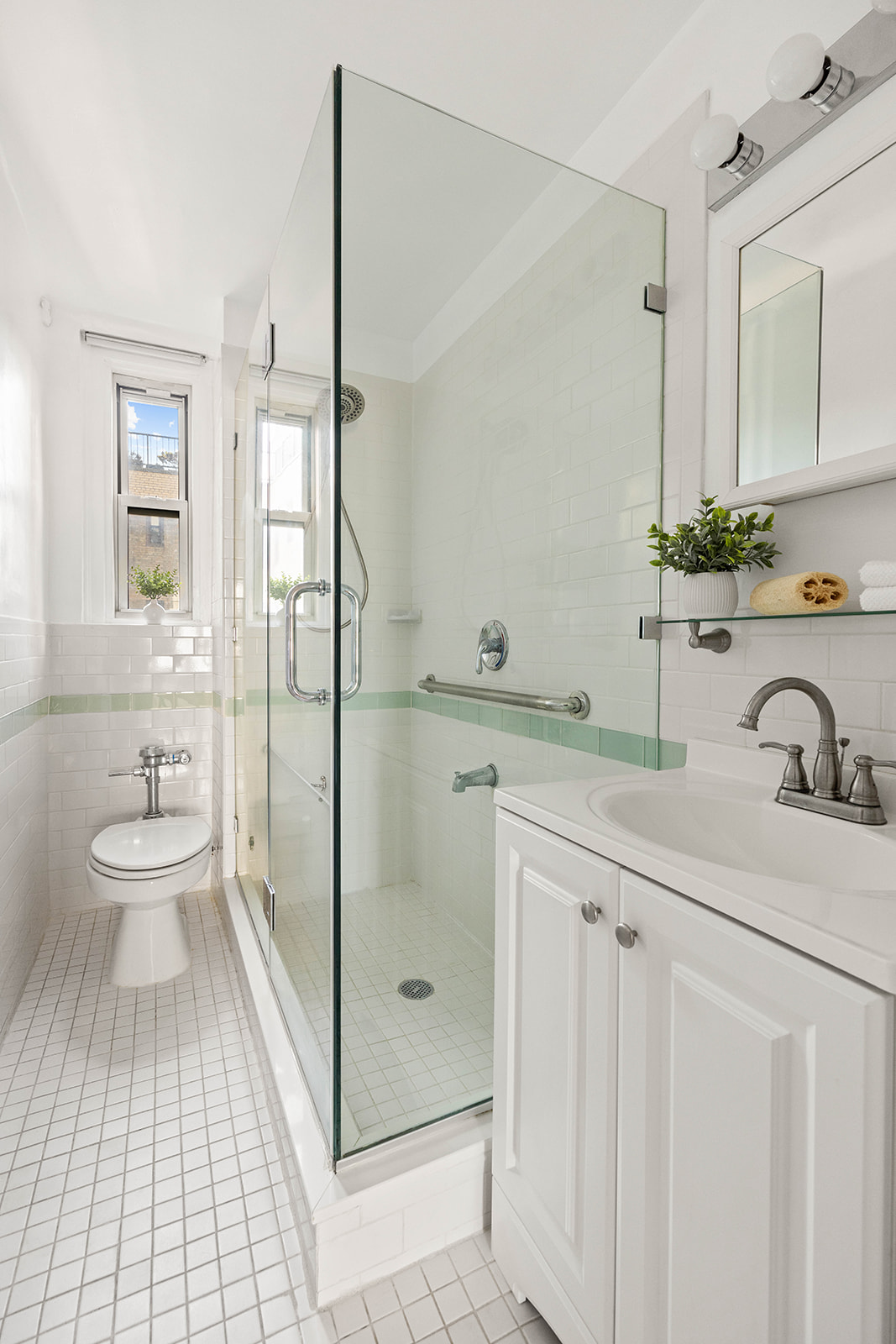 70 Remsen Street, Unit 9C Brooklyn, NY 11201 - Photo 8 of 11 a spacious bathroom with a shower sink and mirror