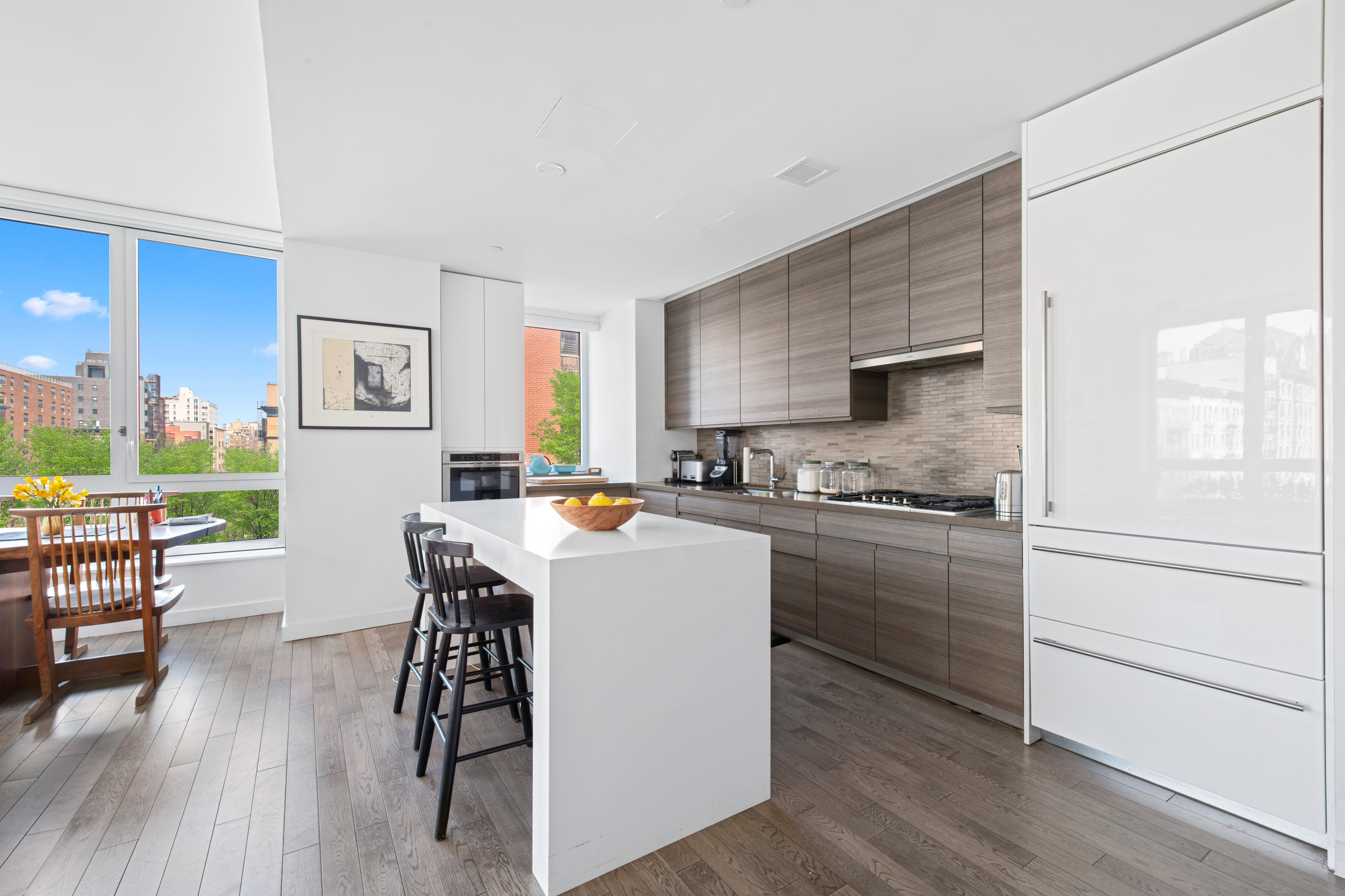 285 West 110th Street, Unit 4B Manhattan, NY 10026 - Photo 3 of 14 a kitchen with a table chairs refrigerator and cabinets