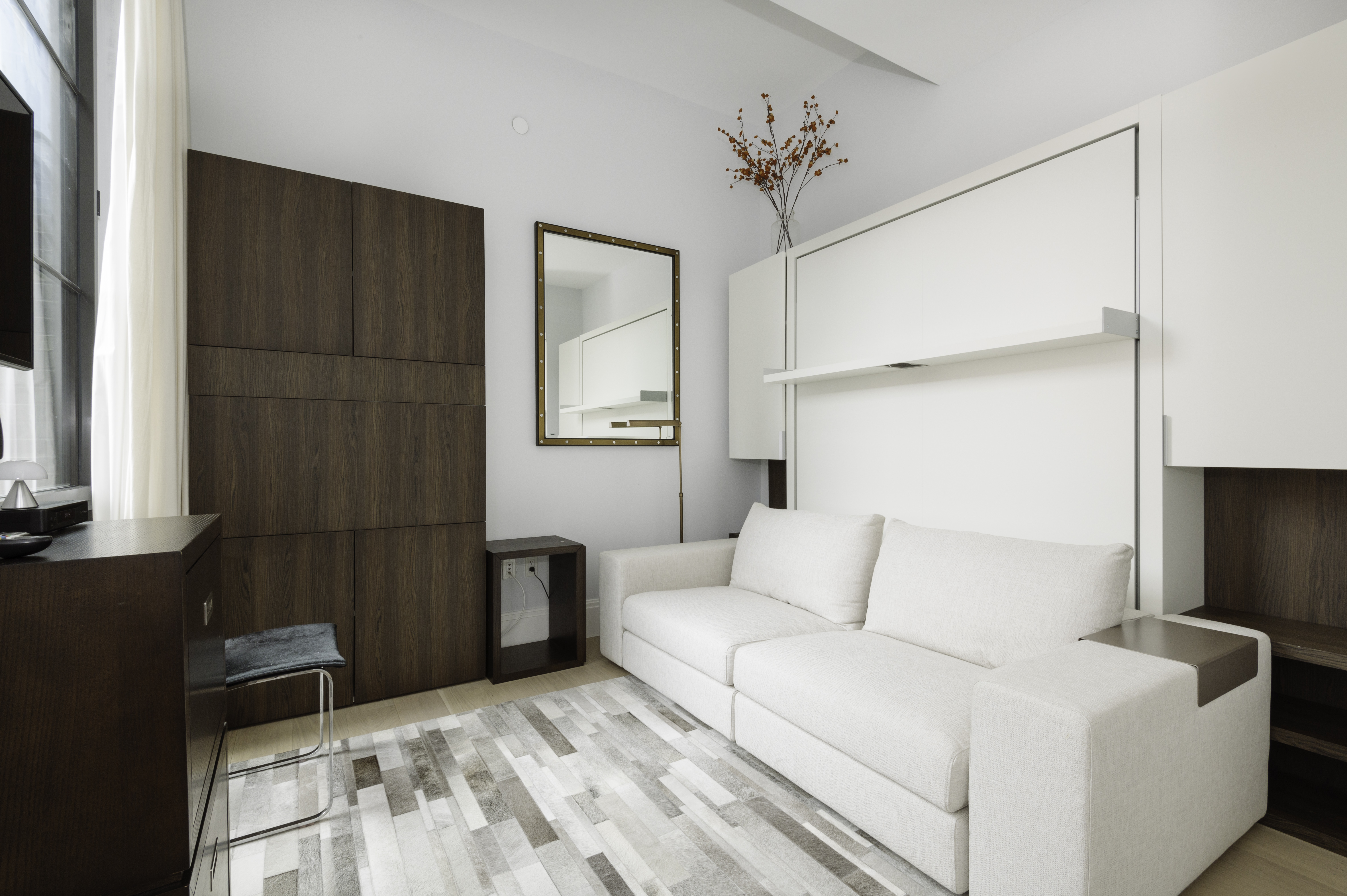 438 East 12th Street, Unit 6J Manhattan, NY 10009 - Photo 5 of 14 a bedroom with a large bed and a chandelier