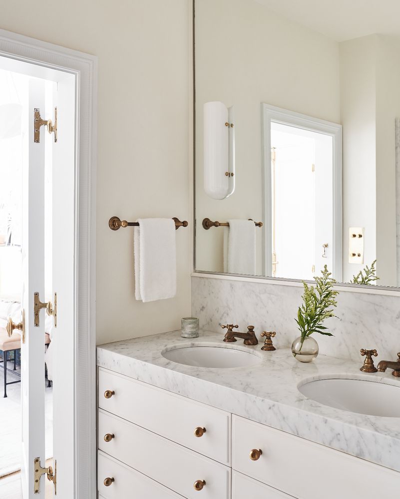 a bathroom with a granite countertop sink a mirror and a shower