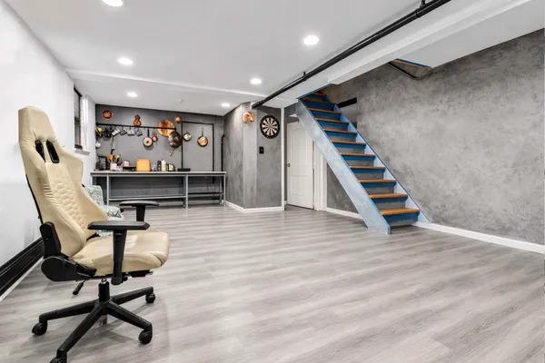 a view of a room with chairs and stairs