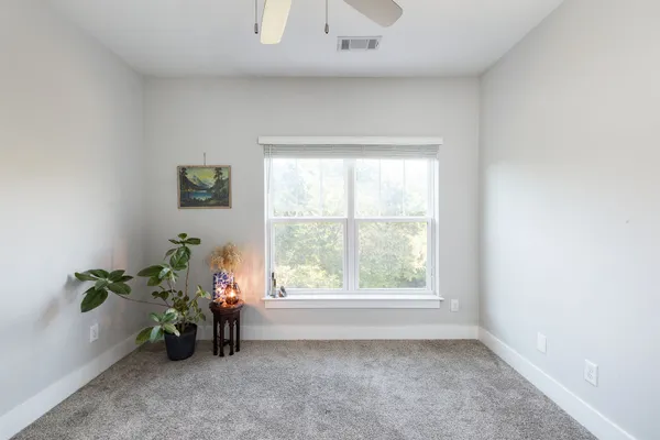 a view of a room that has a window and a potted plant