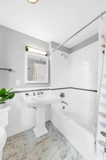 a bathroom with a sink a mirror and a bathtub