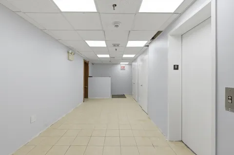 a view of a hallway with chandelier