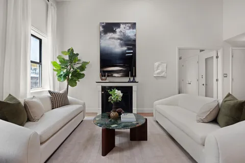a living room with furniture flowerpot and window
