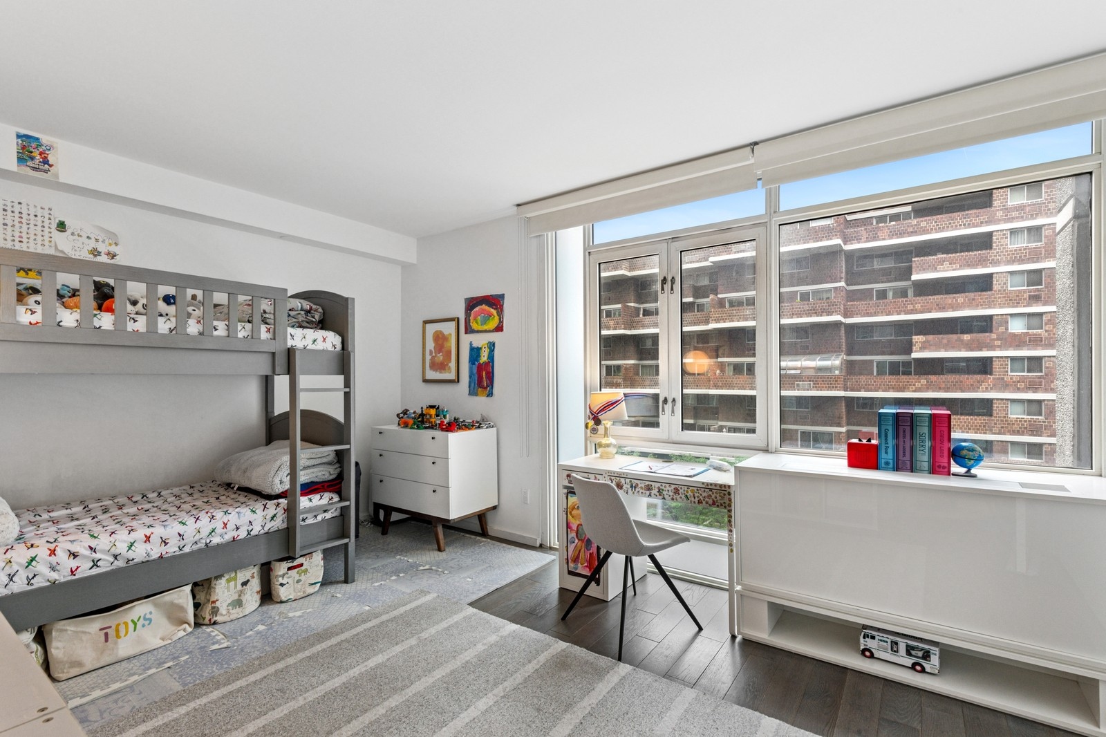 385 1st Avenue, Unit 6B Manhattan, NY 10010 - Photo 8 of 15 a living room with furniture and a book shelf