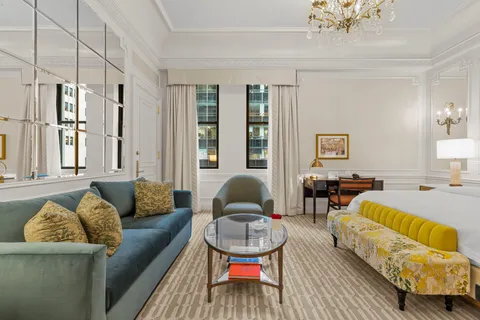 a living room with furniture ceiling fan and a rug