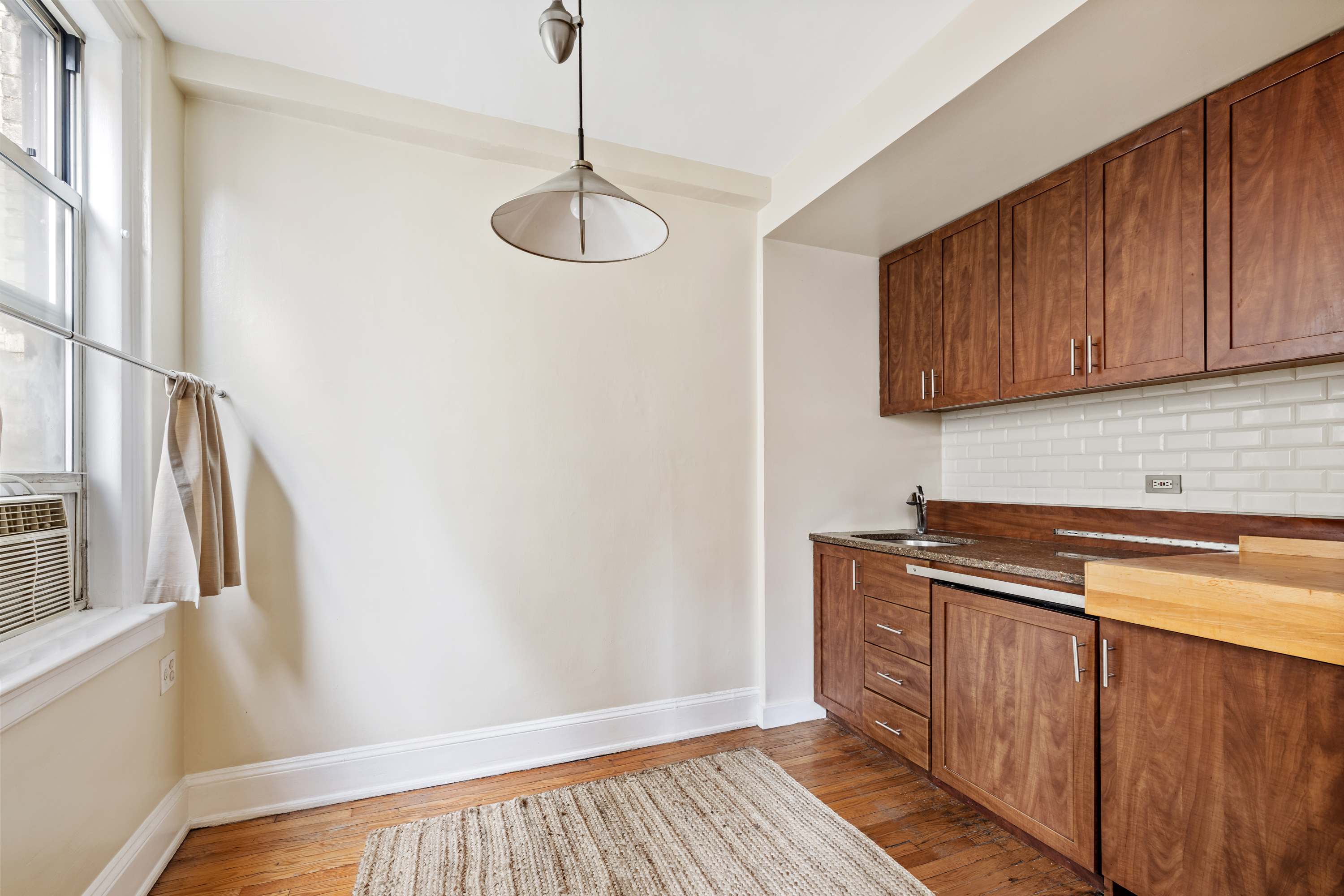 136 East 36th Street, Unit 5D Manhattan, NY 10016 - Photo 5 of 13 a area with wooden floor and cabinets