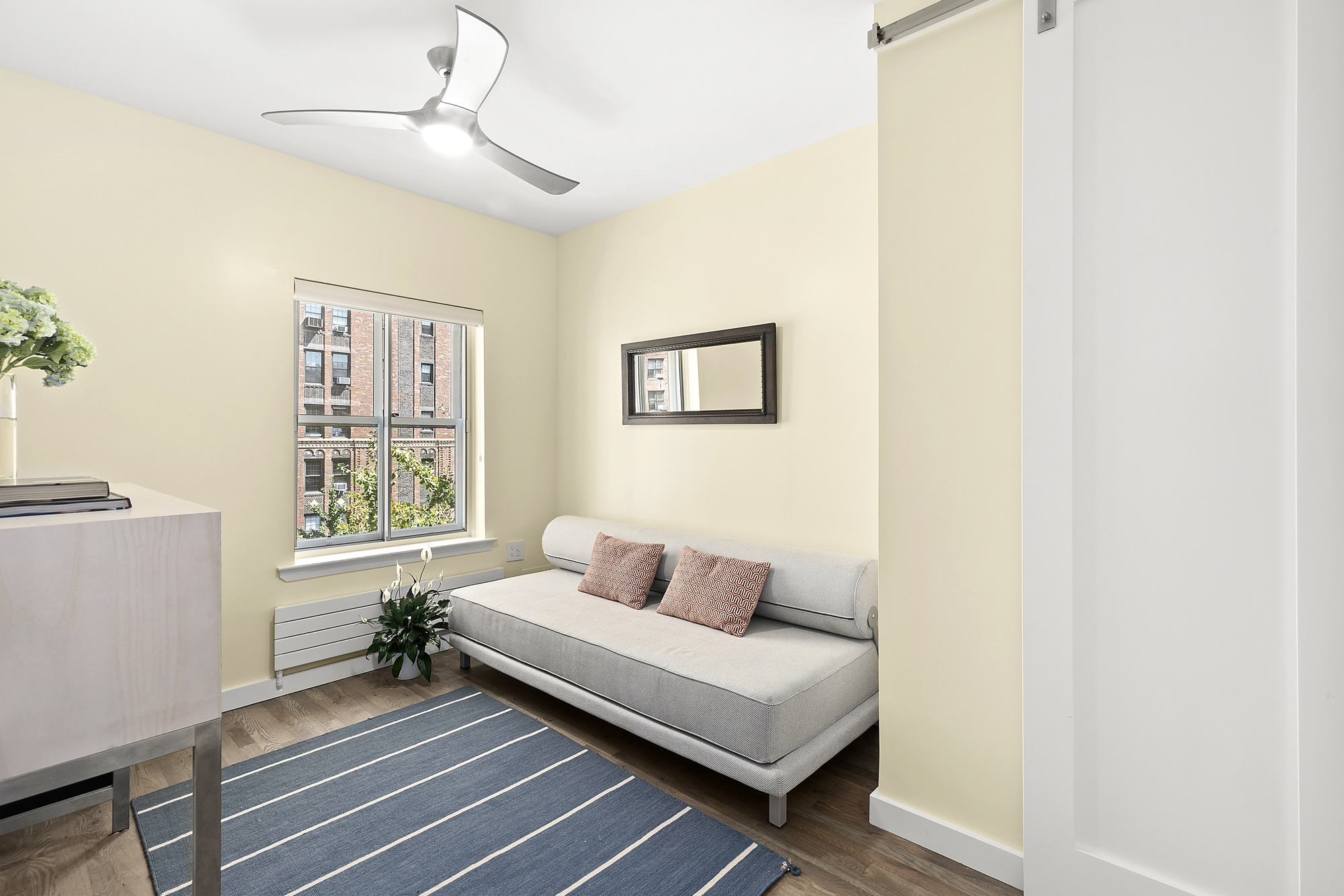 450 West 23rd Street, Unit E Manhattan, NY 10011 - Photo 7 of 12 a bedroom with a bed and a window