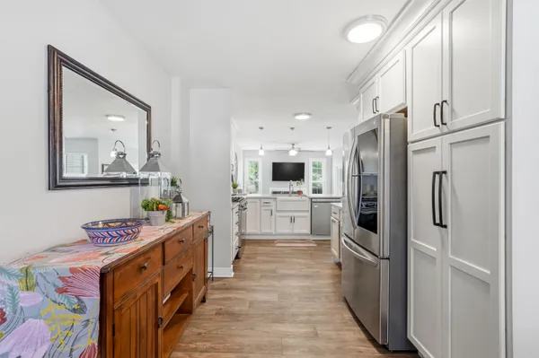a kitchen with stainless steel appliances a refrigerator sink and cabinets