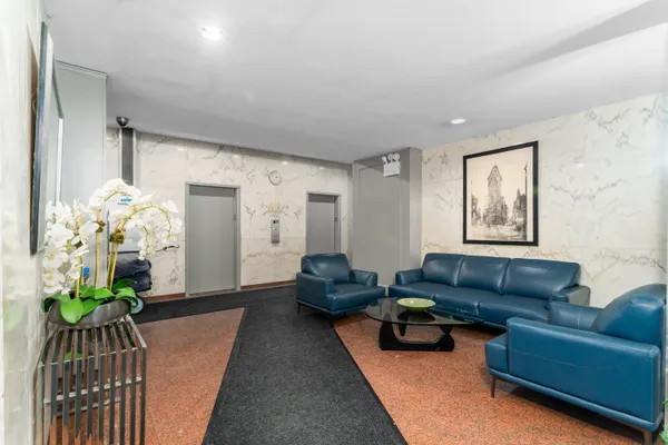 a living room with furniture and a chandelier