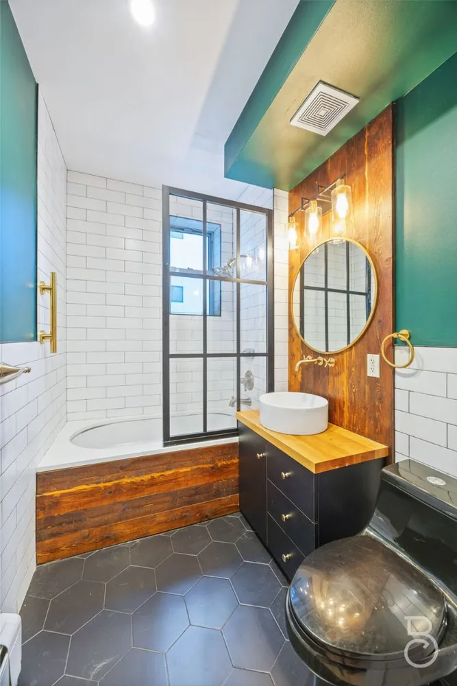 a bedroom with a bed and a mirror