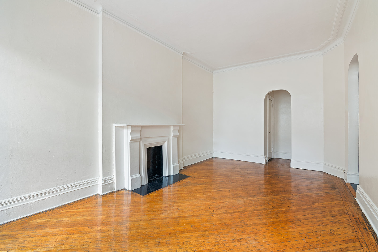 65 East 80th Street, Unit 3B Manhattan, NY 10075 - Photo 2 of 5 a view of an empty room with window and a fireplace
