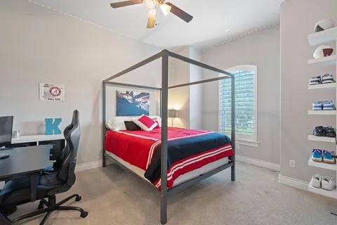 a room with a bed a desk and chair