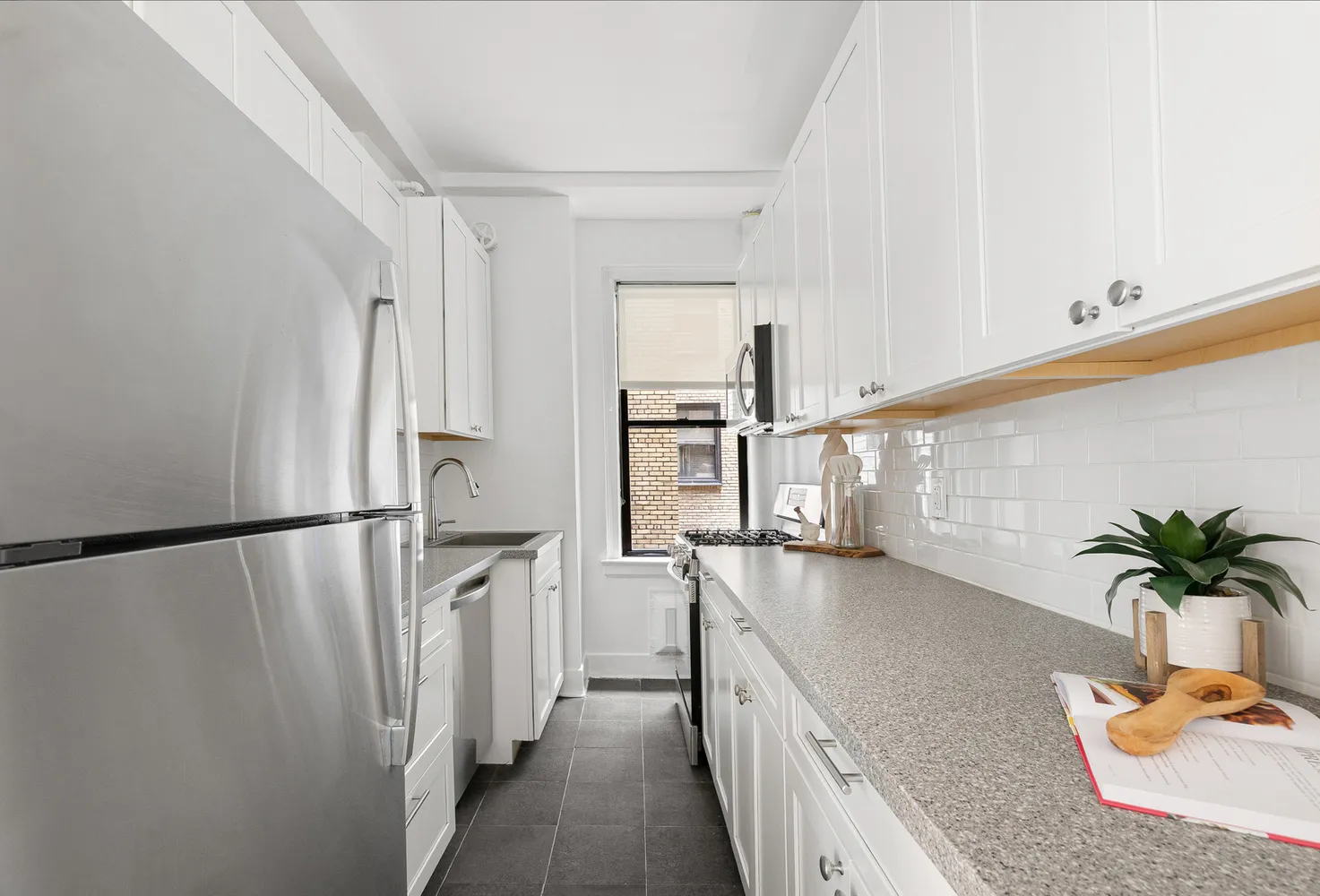 a kitchen with stainless steel appliances a refrigerator a sink