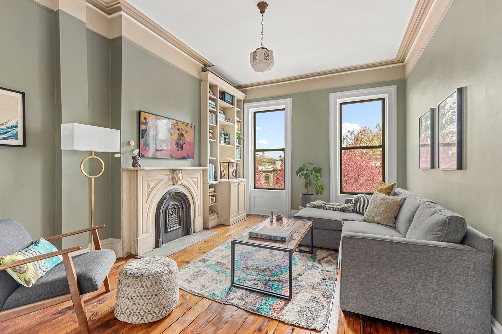 417 6th Street Brooklyn, NY 11215 - Photo 11 of 21 a living room with furniture a fireplace and a floor to ceiling window