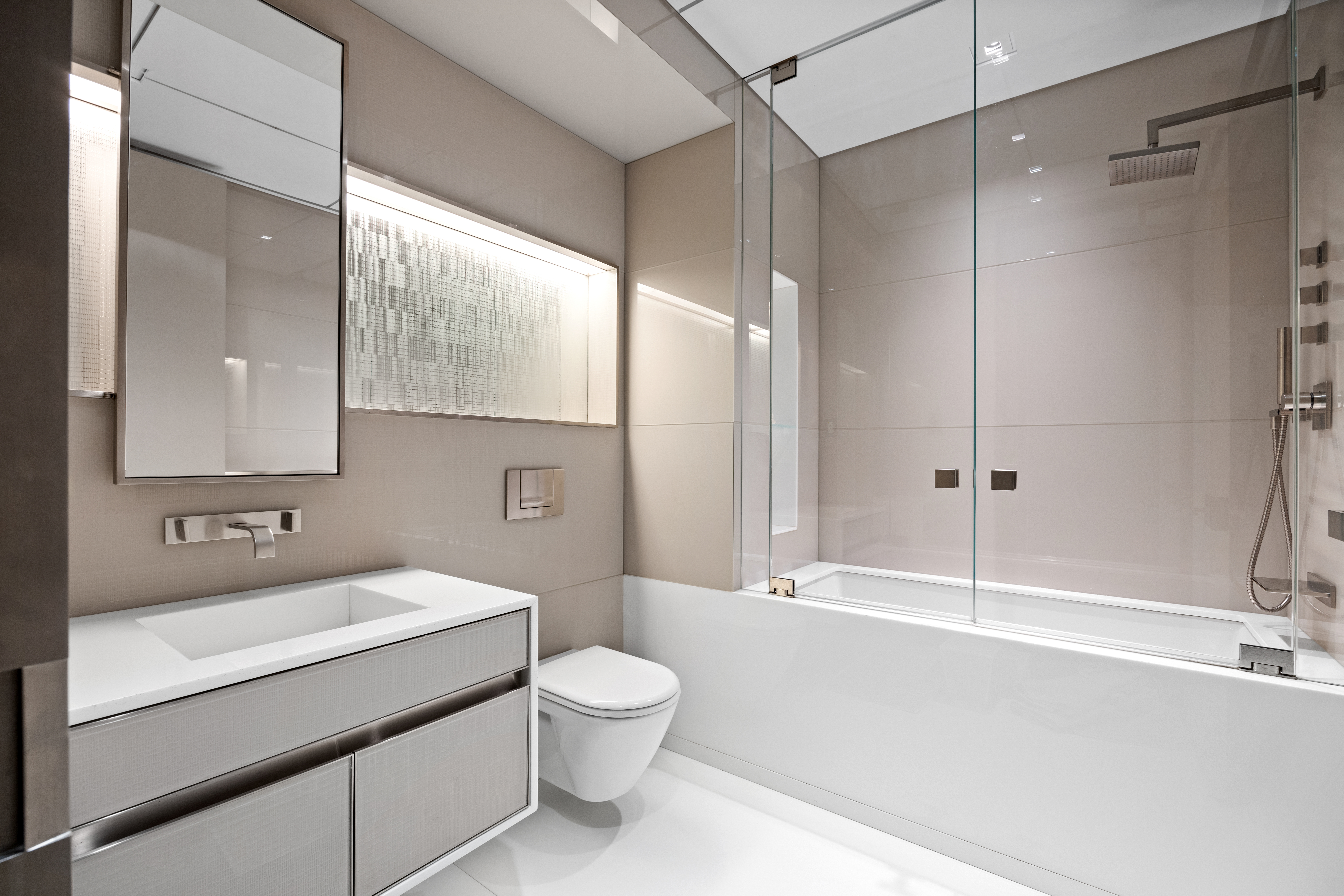 219 East 67th Street, Unit 5 Manhattan, NY 10065 - Photo 16 of 18 a bathroom with a sink a toilet and shower