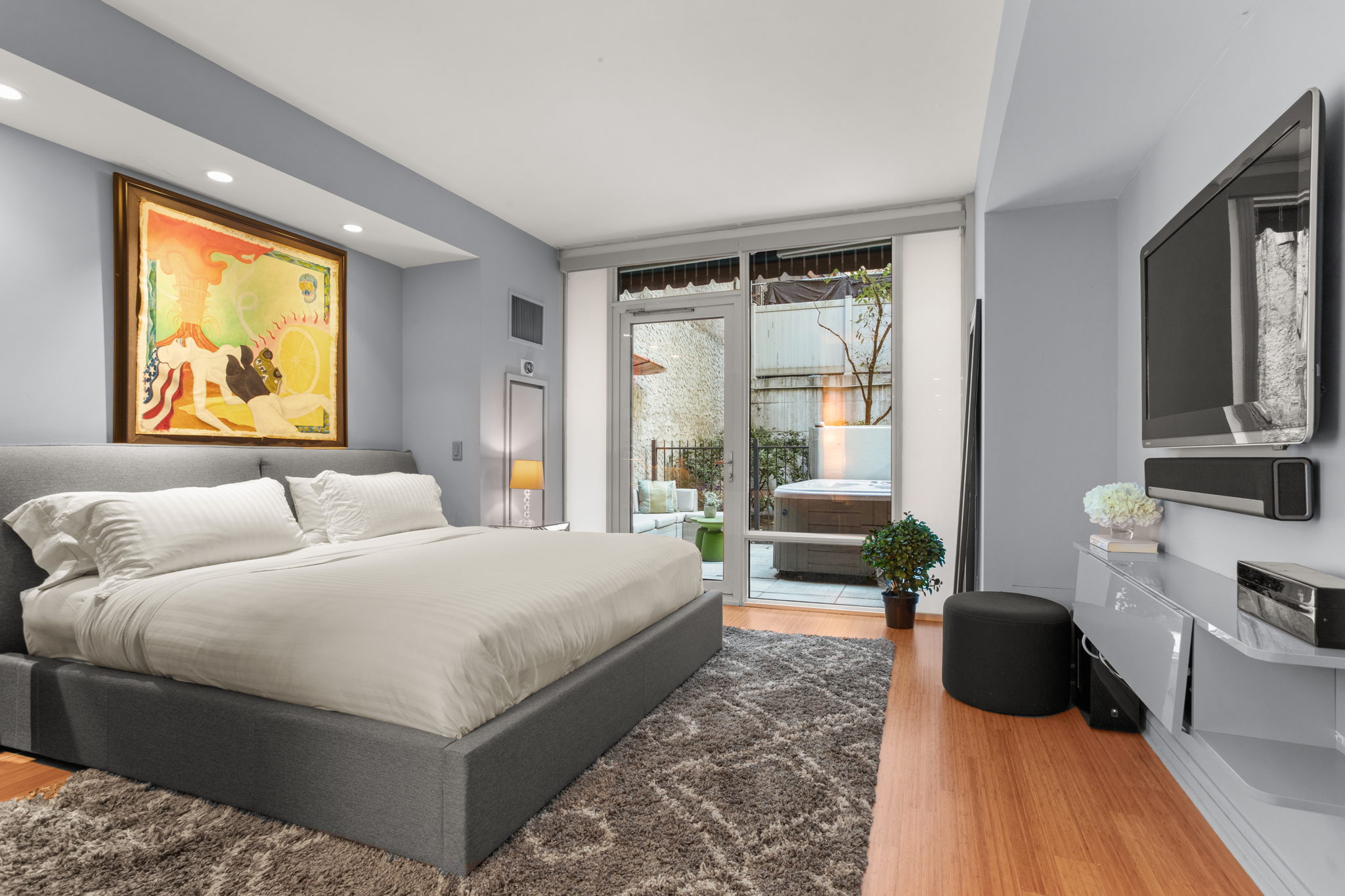 350 West 53rd Street, Unit THG Manhattan, NY 10019 - Photo 12 of 25 a bedroom with a large bed and a couch