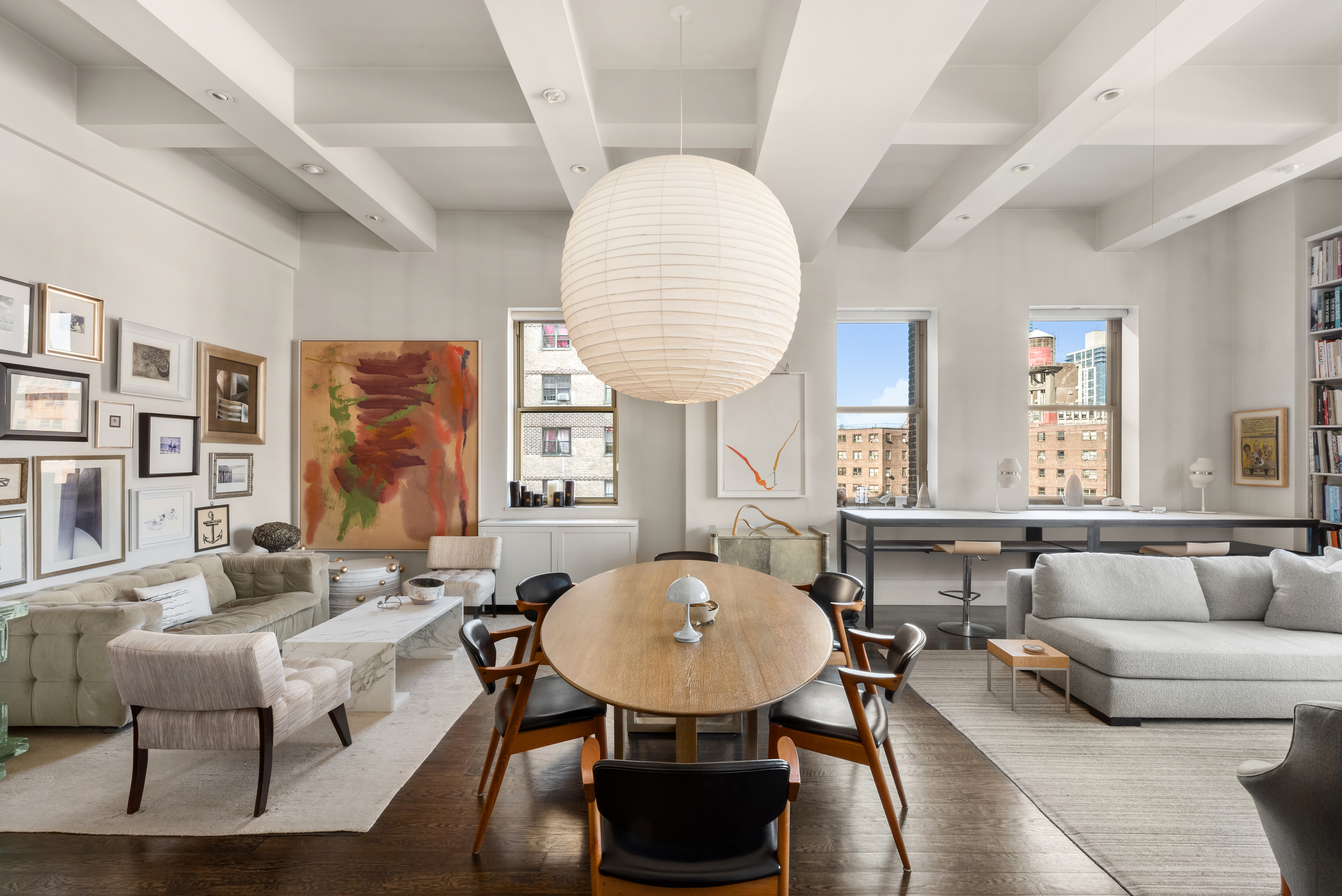 263 9th Avenue, Unit 7E Manhattan, NY 10001 - Photo 7 of 17 a living room with furniture a table and a large window