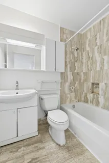 a bathroom with a sink toilet and shower