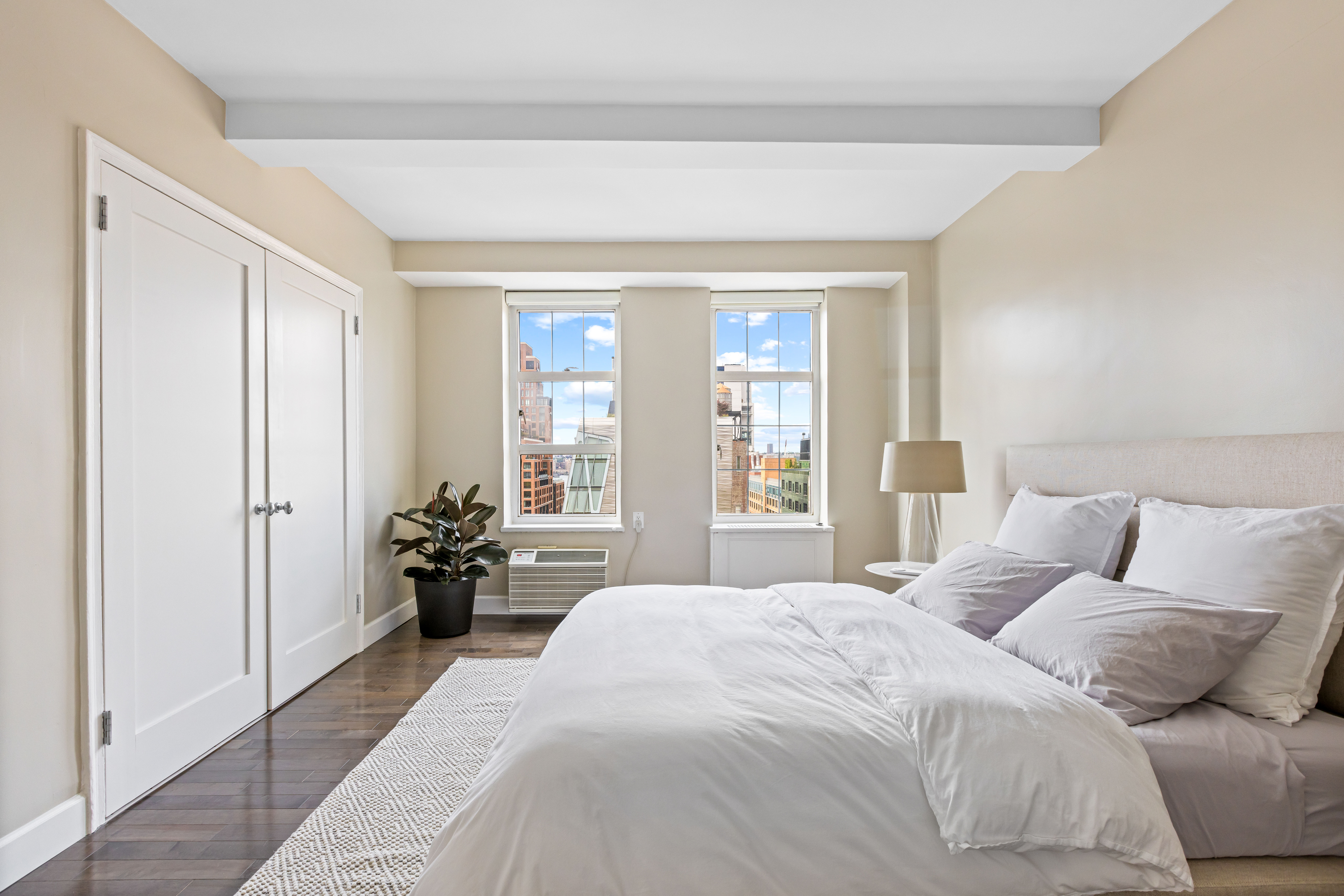 465 West 23rd Street, Unit 15B Manhattan, NY 10011 - Photo 8 of 19 a bedroom with a bed and a large window